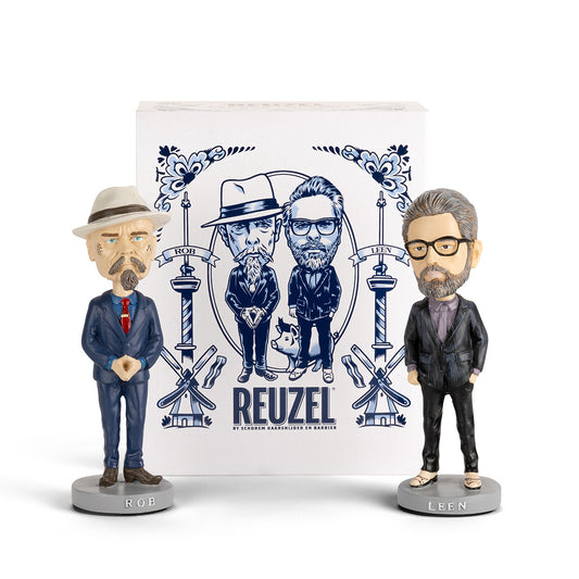 Vendor's barber pole display with two vintage-style bobblehead figures, showcasing a classic barber shop decor accessory.