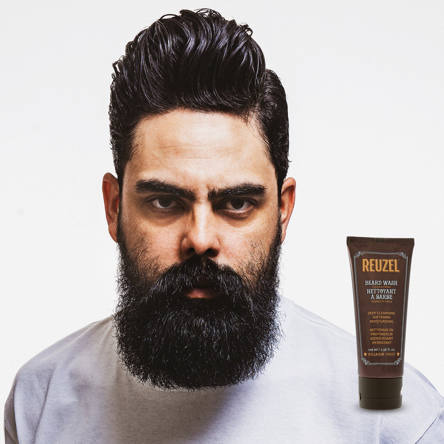 Male model with short black hair and beard REUZEL beard wash