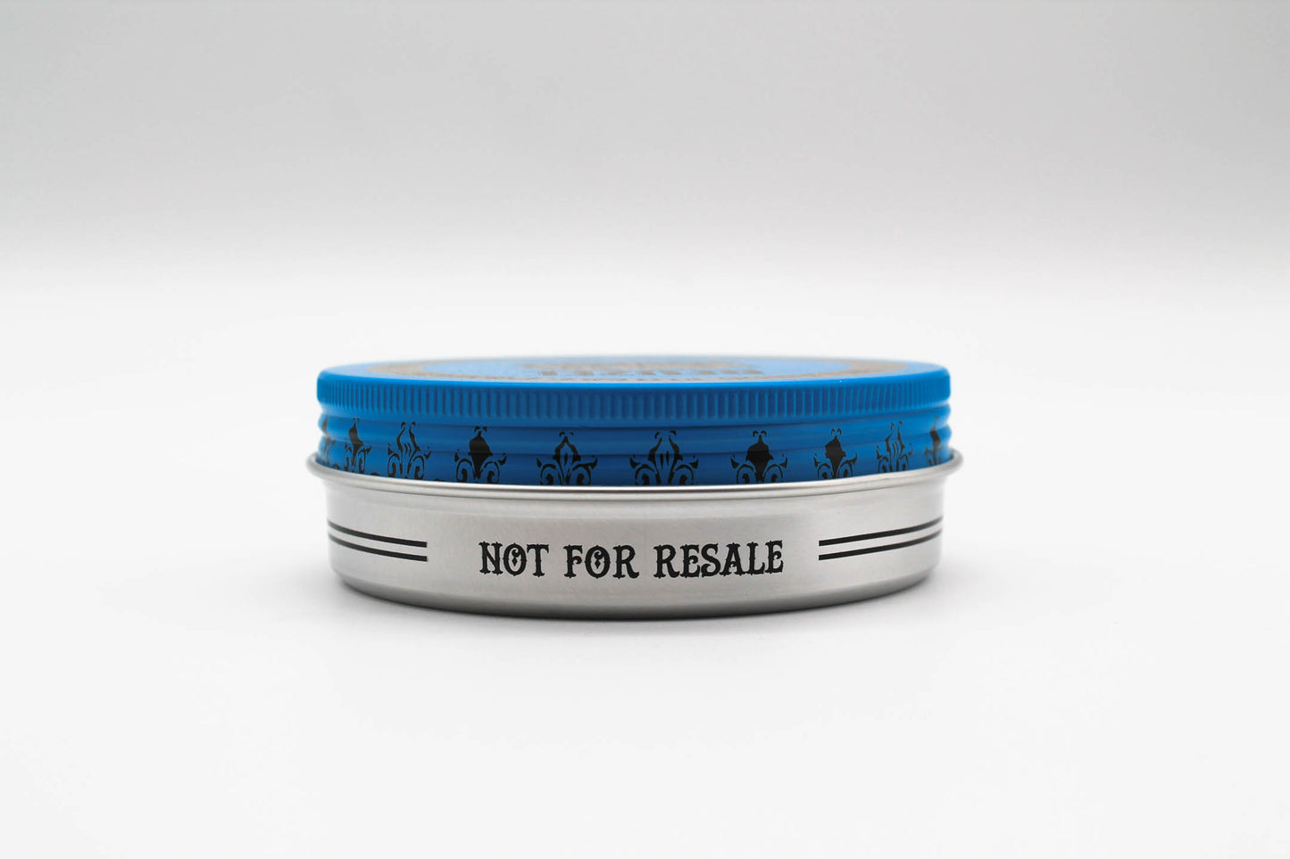 Blue Reuzelinc pomade jar with a blue label, showcasing the product's smooth, shiny texture and classic pomade container.