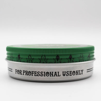Green Reuzelinc pomade grease jar with green label and lid, showing the thick, shiny hair styling product inside.