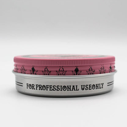Reuzelinc pink pomade grease jar with a black lid, showing vibrant pink product inside, ideal for styling and shaping hair.