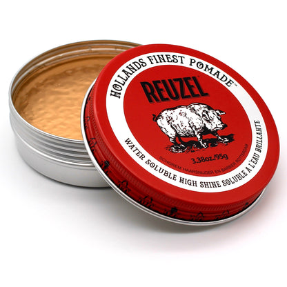 Red water-soluble pomade by Reuzel, showcasing a glossy finish and smooth texture for stylish hair styling.