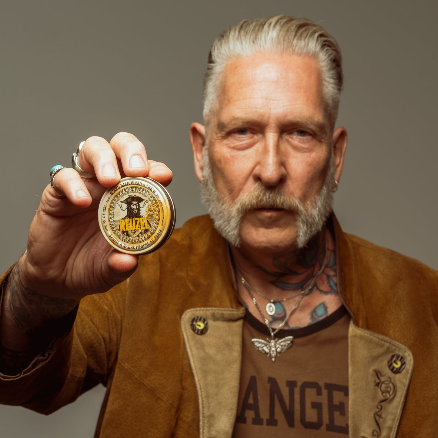 Man with brown hair and beard styled with Wood & Spice Beard Balm REUZEL 