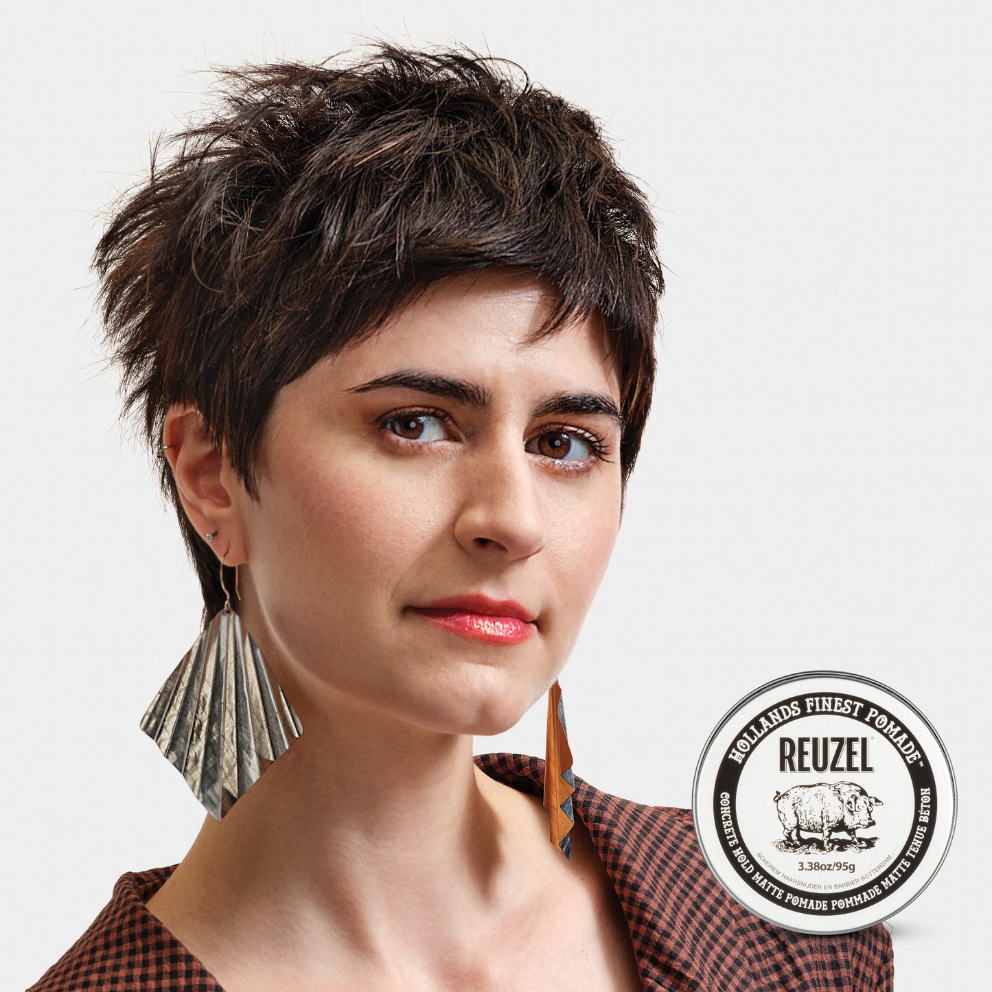 Woman with shaggy brown hair, styled with Reuzel Concrete Hold Matte Pomade