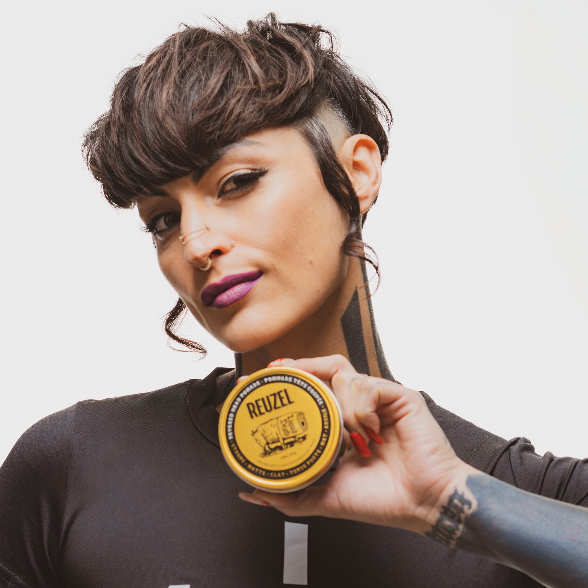 Severed Head Clay Pomade by Vendor in a sleek container, showcasing a textured hair styling product.