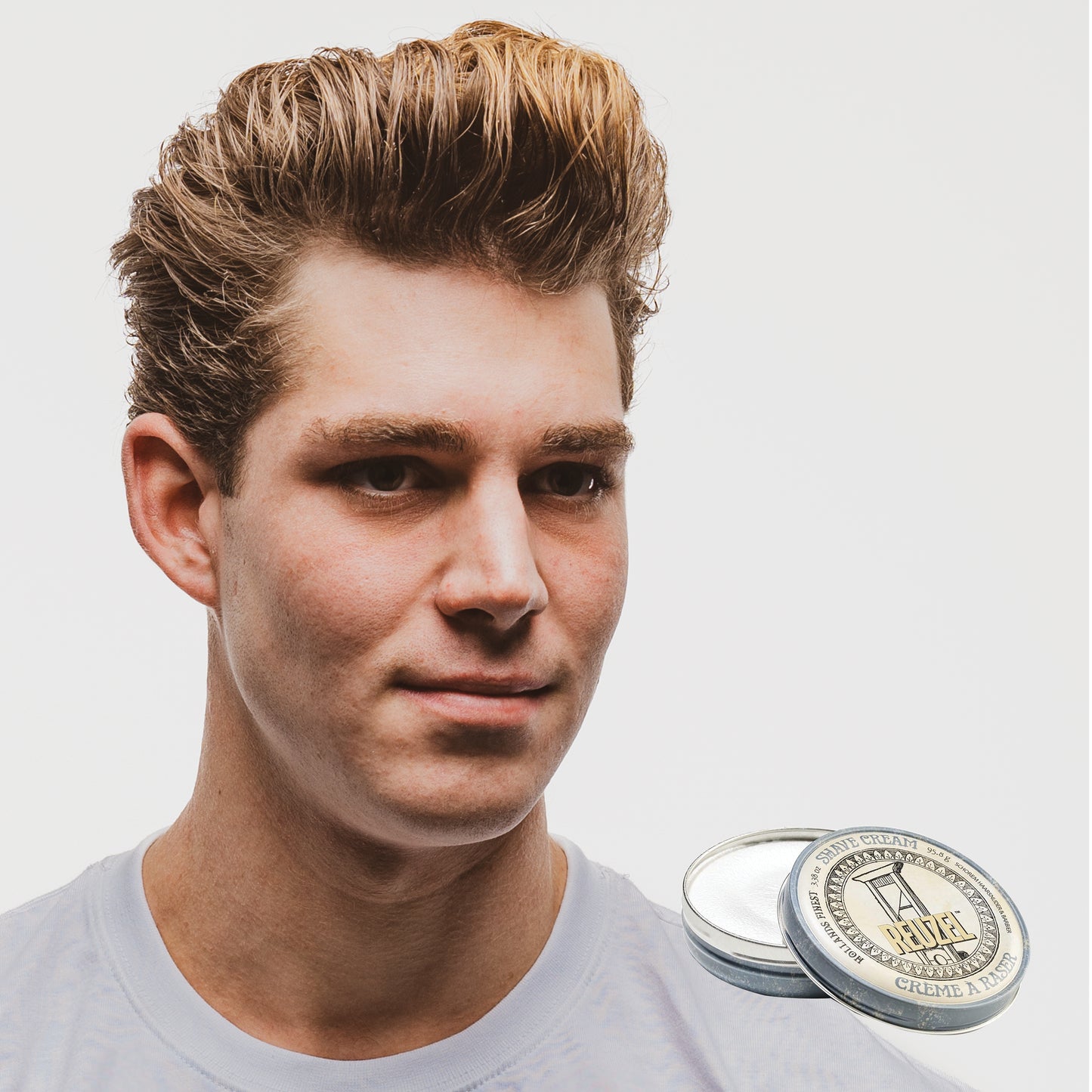 MAN WITH Cleanly shaved face using REUZEL Shave Cream